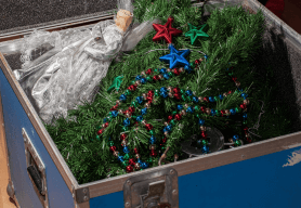 an open blue box contains festive garlands an christmas decorations.