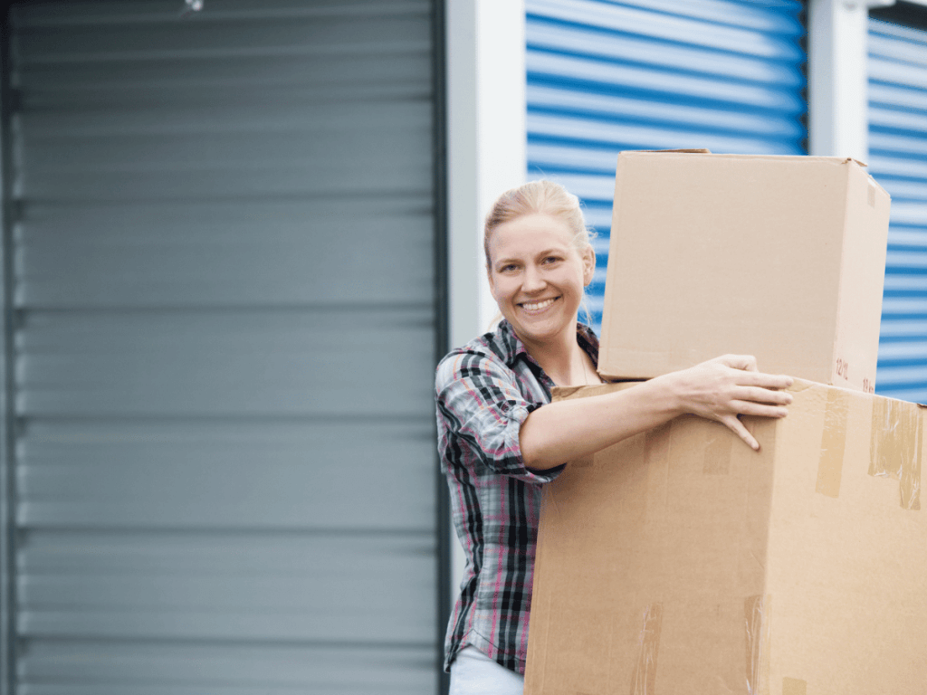 A woman is smiling as she collects boxes from her long term local storage unit.